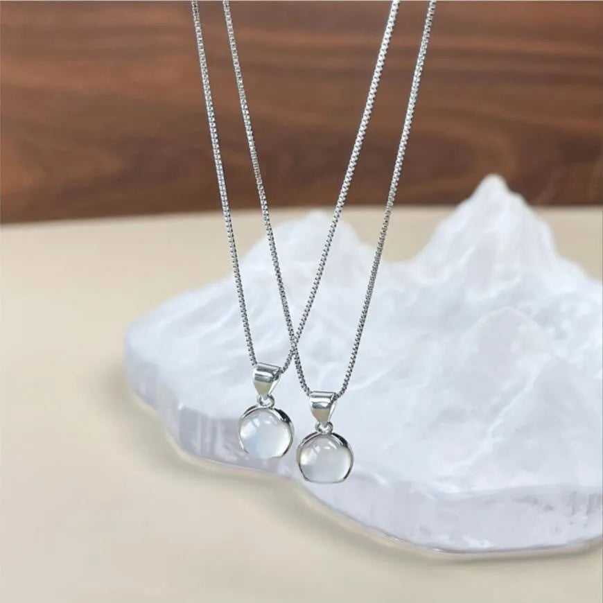 Women's oval geometric pendant necklace with eight awn star crystal on an adjustable box chain.