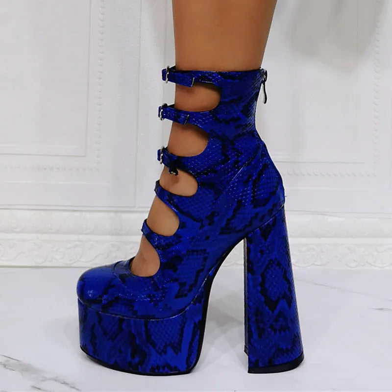 Women's black patent leather platform ankle boots with a thick heel and serpentine buckle fastening.