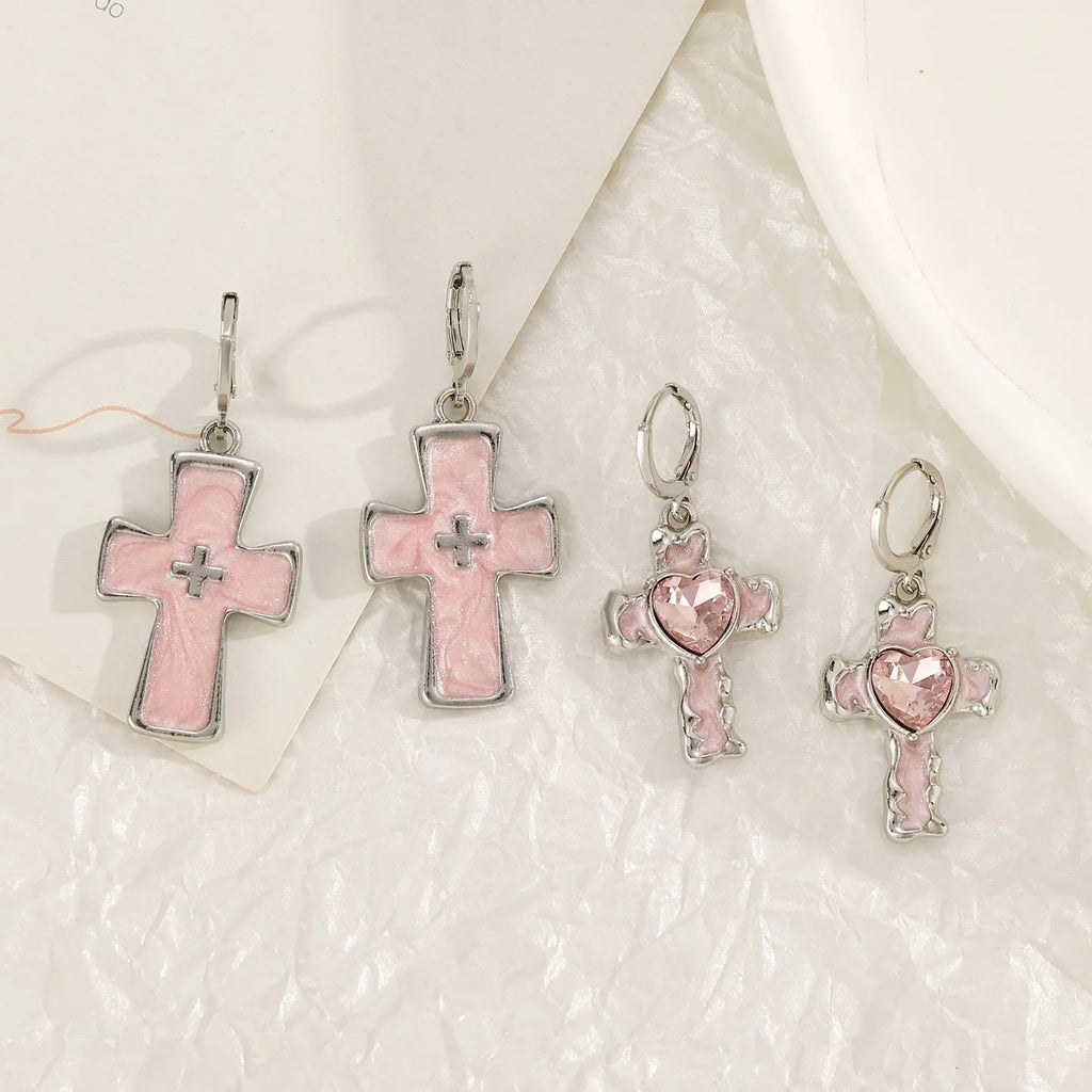 Women's alloy crystal earrings showing five colour options: white cross, white peach heart, white cross, black cat, and antique silver star design.