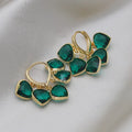 Green glass heart-shaped pendant on copper ear clip earrings with alloy inlay detail.