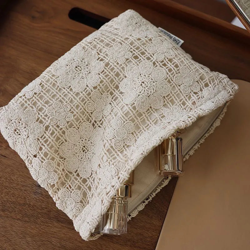 Handmade crocheted cosmetic bag with floral embroidery on corduroy fabric and rope drawstring