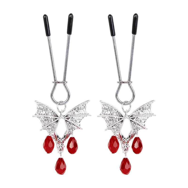 Silver bat-shaped nipple clamp with ruby accent detail and adjustable pressure mechanism