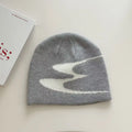 Acrylic thermal knit beanie hat in black, shown on a model, illustrating its textured anti-fall design.