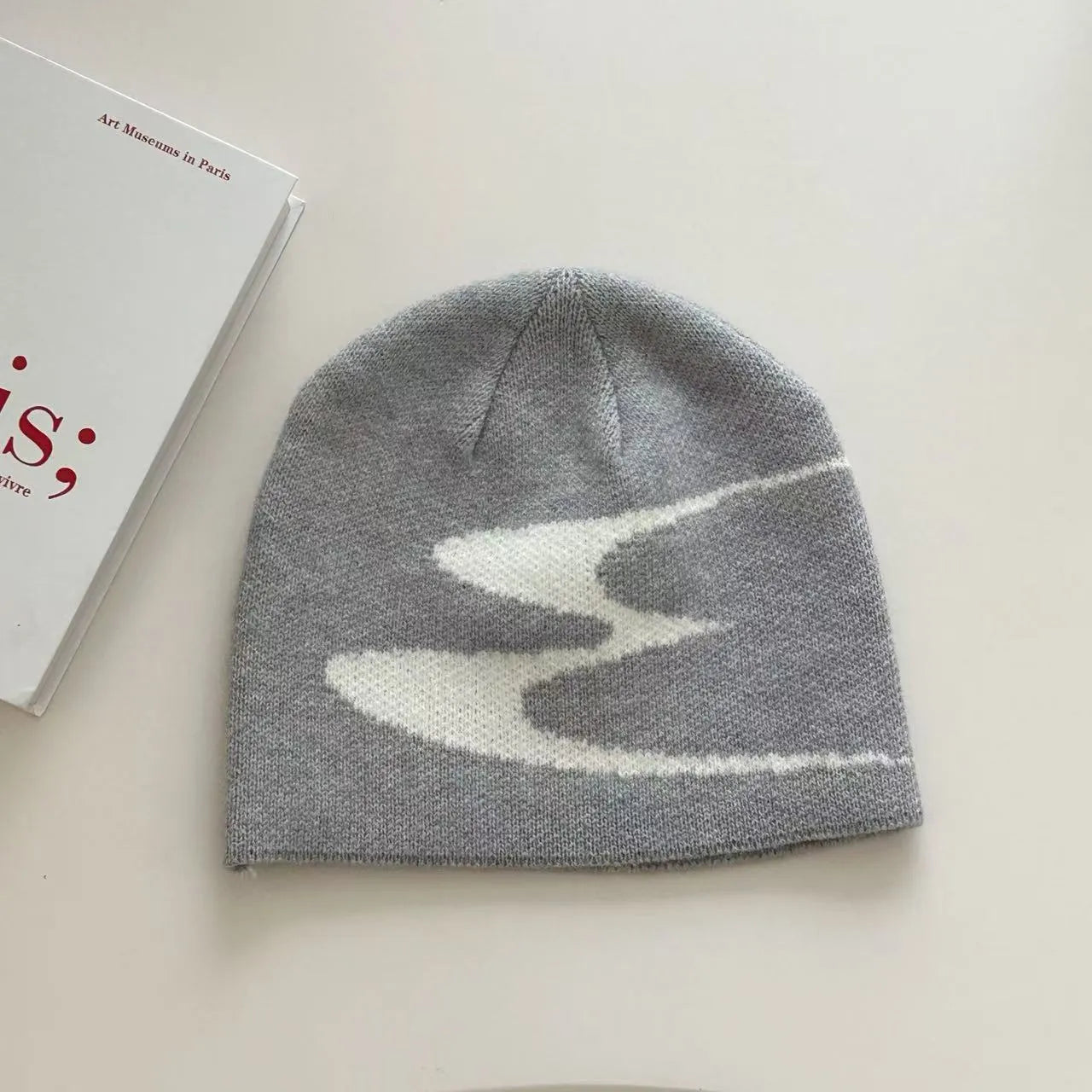 Acrylic thermal knit beanie hat in black, shown on a model, illustrating its textured anti-fall design.