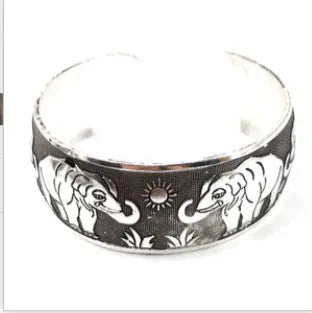 Ethnic carved Miao silver style alloy bracelet in open design with turtle or elephant colour motifs