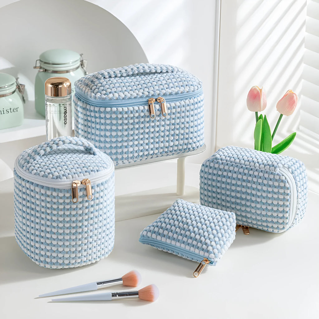 Four cube-shaped flannelette makeup bags in matching blue with dots design