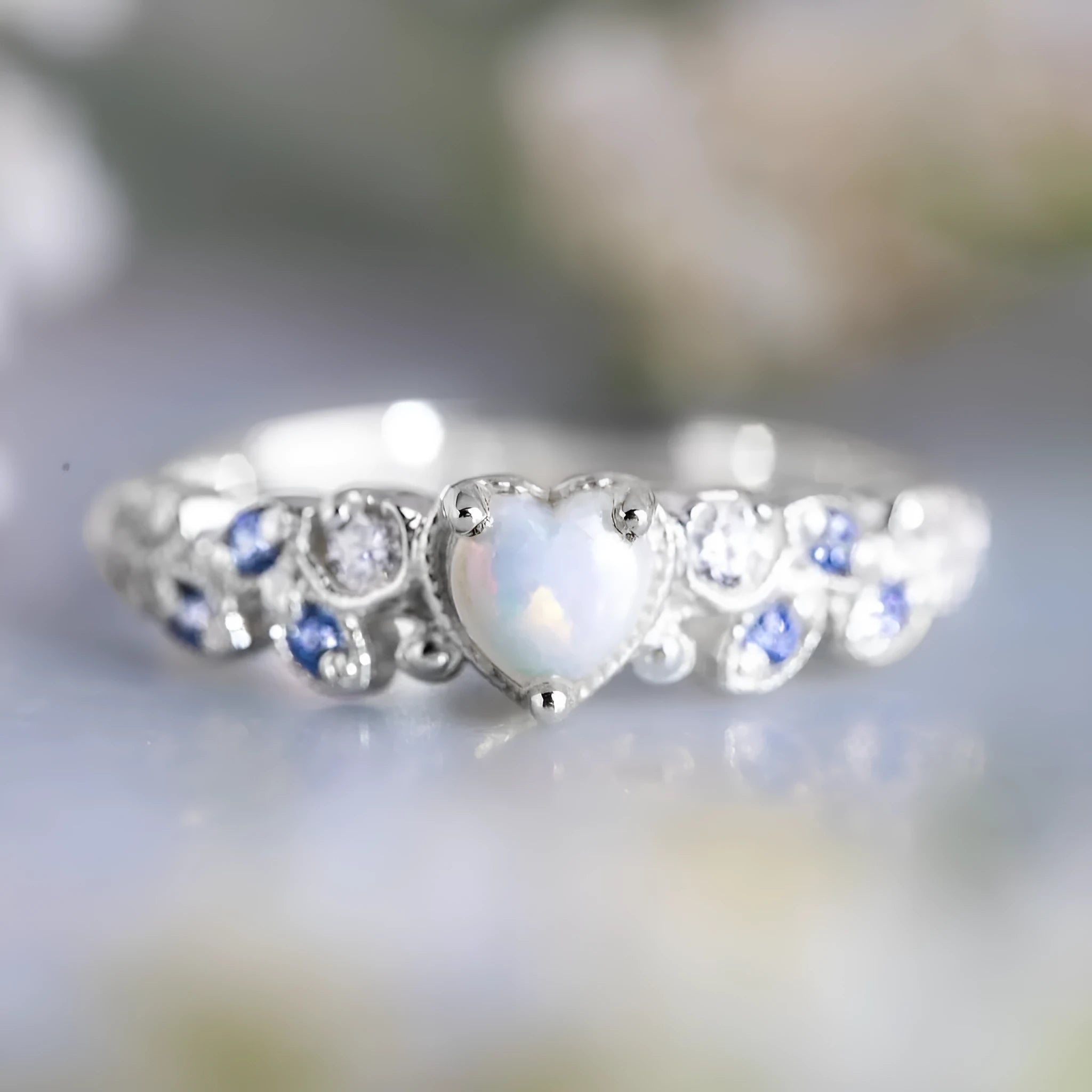White alloy women's heart ring with floral opal ocean design, shown in multiple available sizes