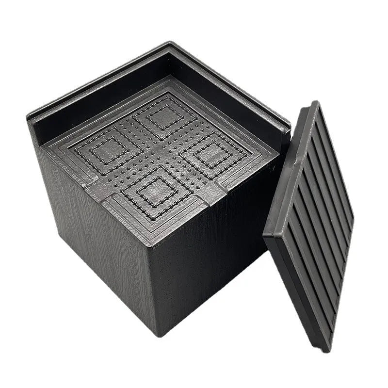 Four black plastic furniture height adjustment mats for sofa or bed feet.