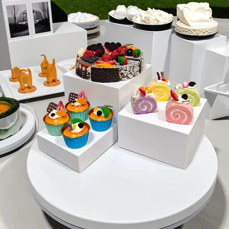 White plastic stackable dessert display stand with six pieces arranged in tiered formation