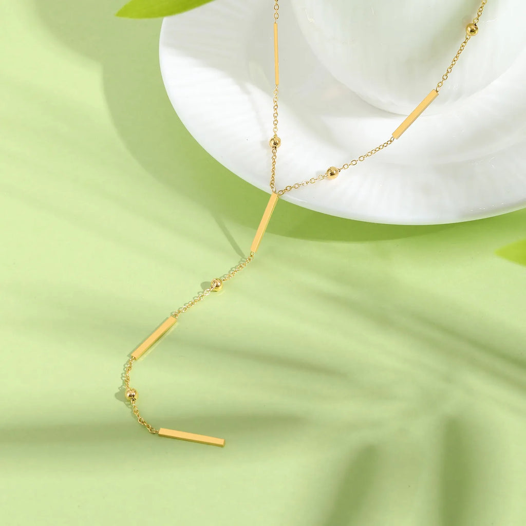 Women's stainless steel gold electroplated geometric pendant necklace on display