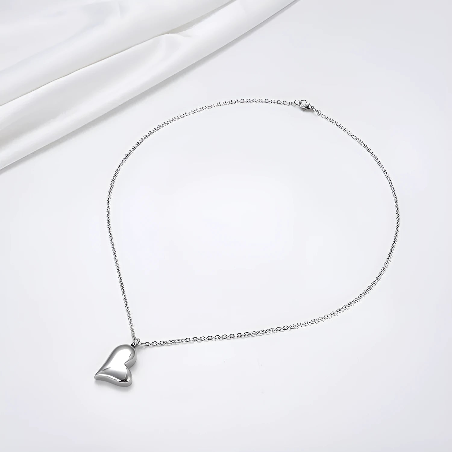 Silver curved peach heart stainless steel pendant necklace on a chain