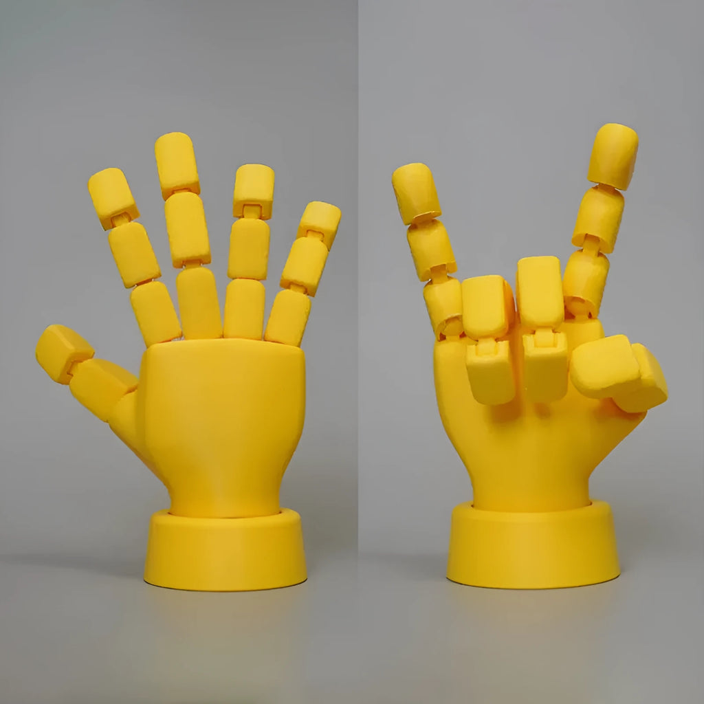 Yellow articulated hand prop with movable joints on a white background.
