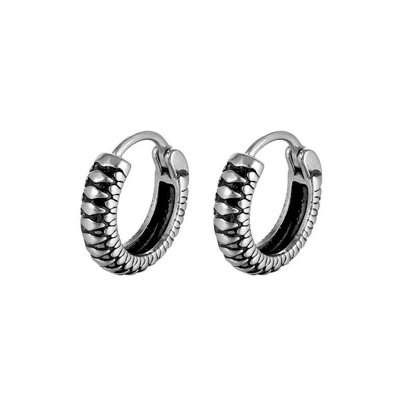 Silver geometric circular earrings made from twisted stainless steel stripes on a white background.