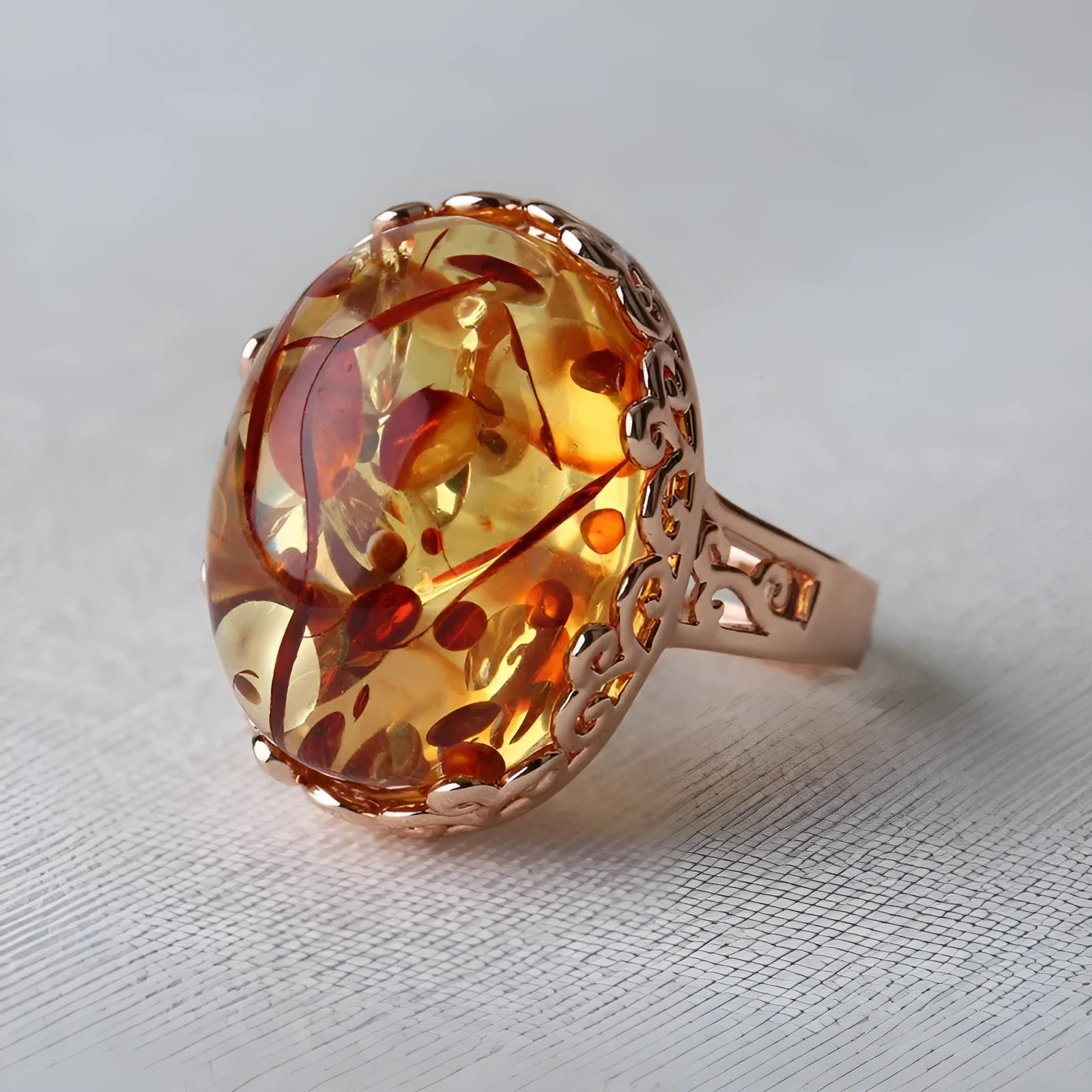 Close-up of an amber ethnic-style beeswax ring with a warm-toned stone and alloy band.