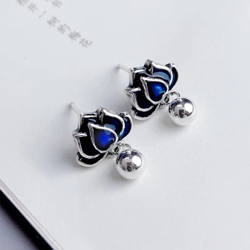 Blue lotus flower stud earrings with a detailed seedpod tassel drop, retro design.