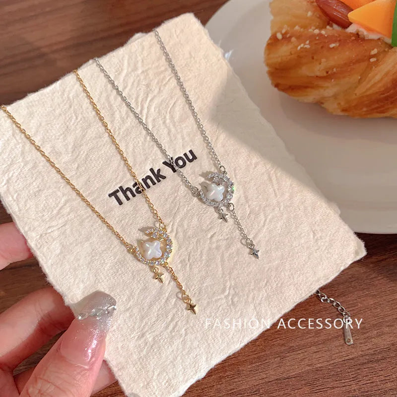 Women's gold star and moon zirconium necklace on an adjustable chain.