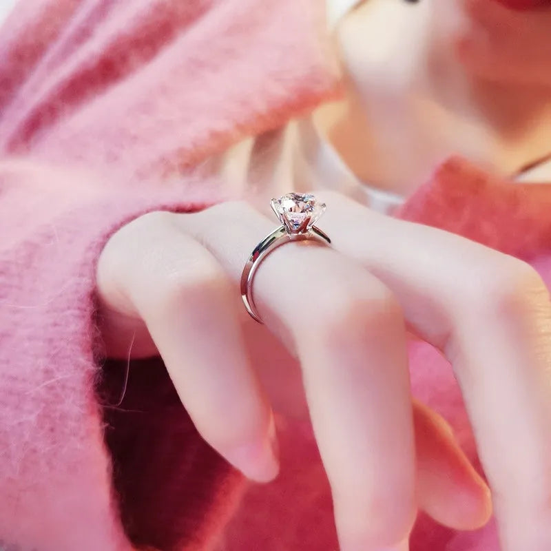 White gold plated women's ring with six-claw cubic zirconia setting on geometry shaped band