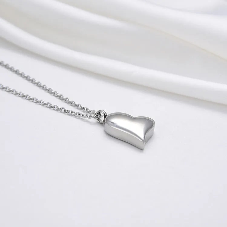 Silver curved peach heart stainless steel pendant necklace on a chain