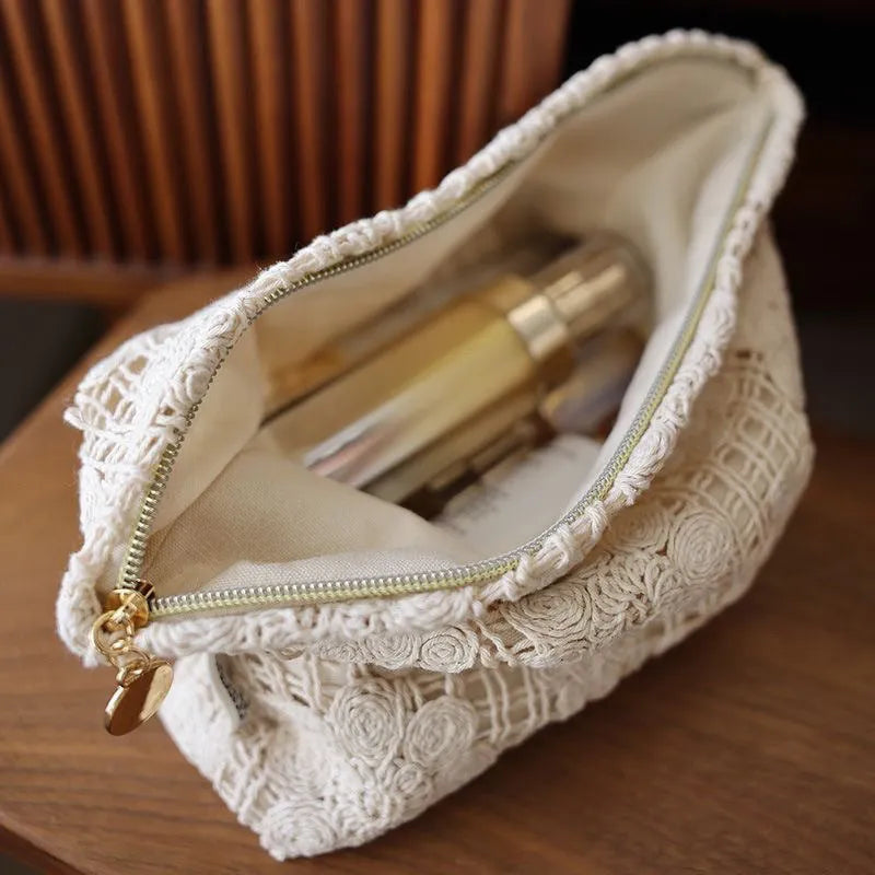 Handmade crocheted cosmetic bag with floral embroidery on corduroy fabric and rope drawstring