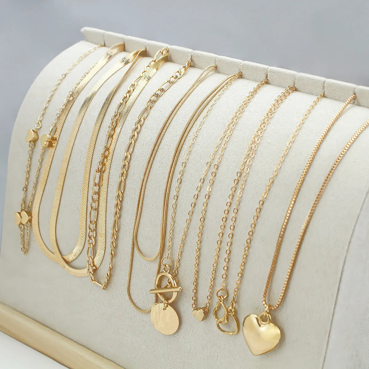 Ten-piece gold women's necklace set with adjustable snake bone chains and alloy pendants