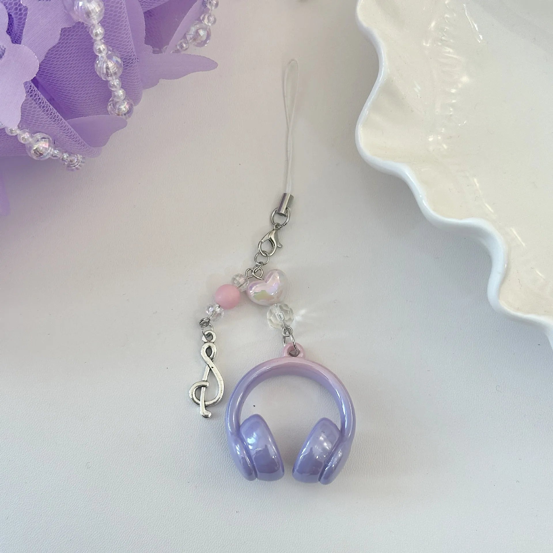 Creative music headset keychain with gradient blue resin earphone pendant and alloy keyring on a plain background