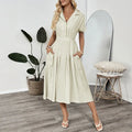 Light green women's shirt dress with lapel collar, waist tie belt, and side seam pockets.
