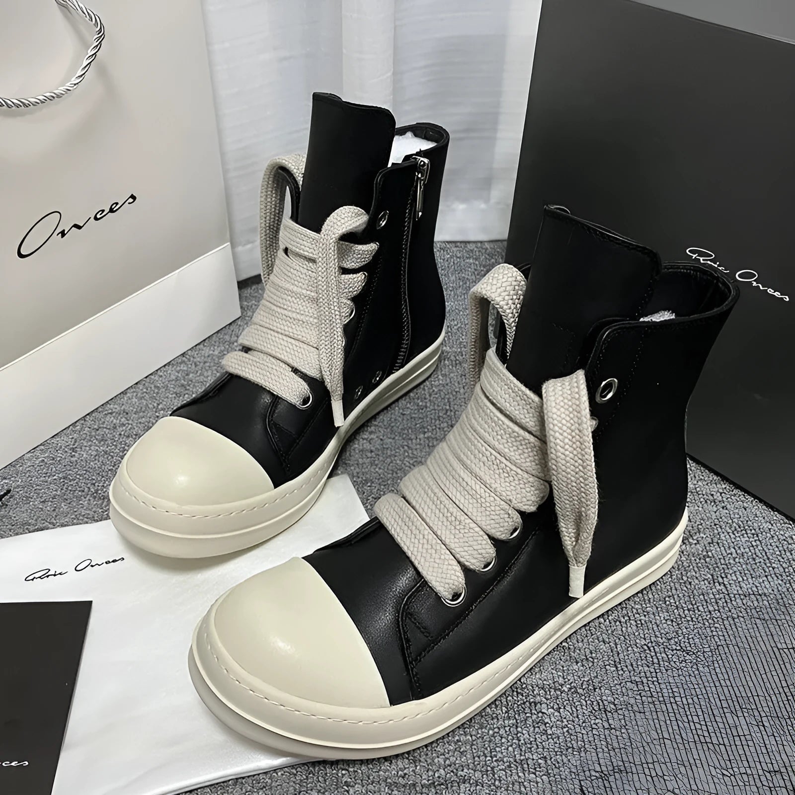 Black genuine leather high-top sneakers with a side zipper on a mid-heel platform sole.