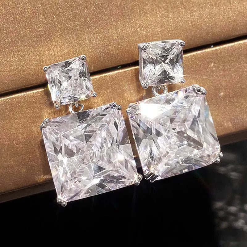 A pair of geometric square-shaped copper earrings for women, shown in white gold and gold colour options.