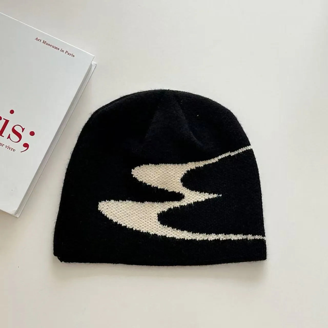 Acrylic thermal knit beanie hat in black, shown on a model, illustrating its textured anti-fall design.