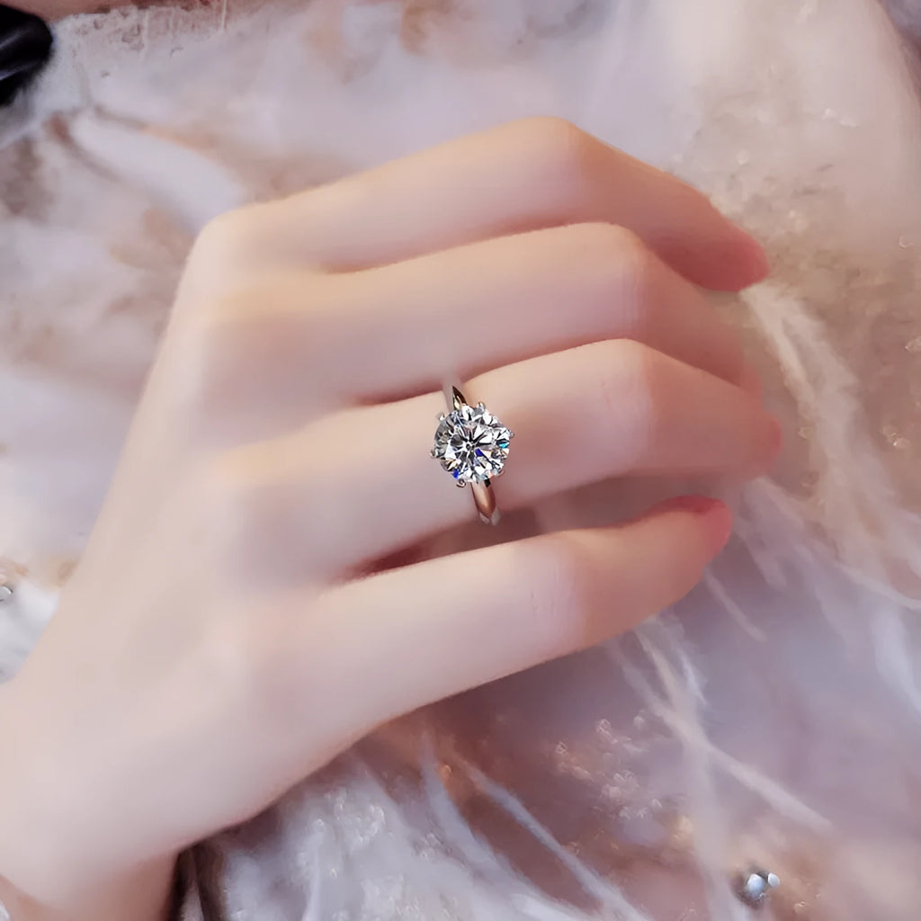 White gold plated women's ring with six-claw cubic zirconia setting on geometry shaped band