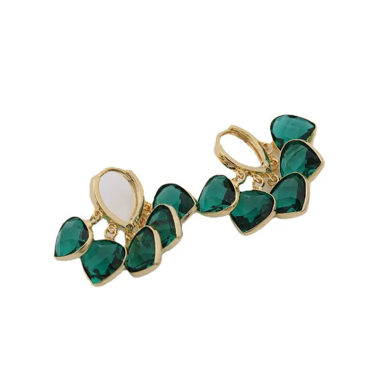 Green glass heart-shaped pendant on copper ear clip earrings with alloy inlay detail.