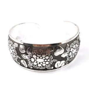 Ethnic carved Miao silver style alloy bracelet in open design with turtle or elephant colour motifs