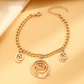 Women's spiral donut charm jewellery set with gold necklace, bracelet and earrings on white background