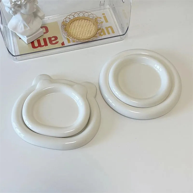 White ceramic plate with chubby bear or round toot design, shown in 15cm and 20cm sizes as a plant tray.