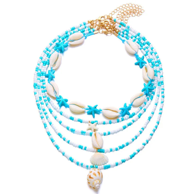 Blue multi-layer women's necklace set with starfish, shell, and conch bead pendants on bead chains