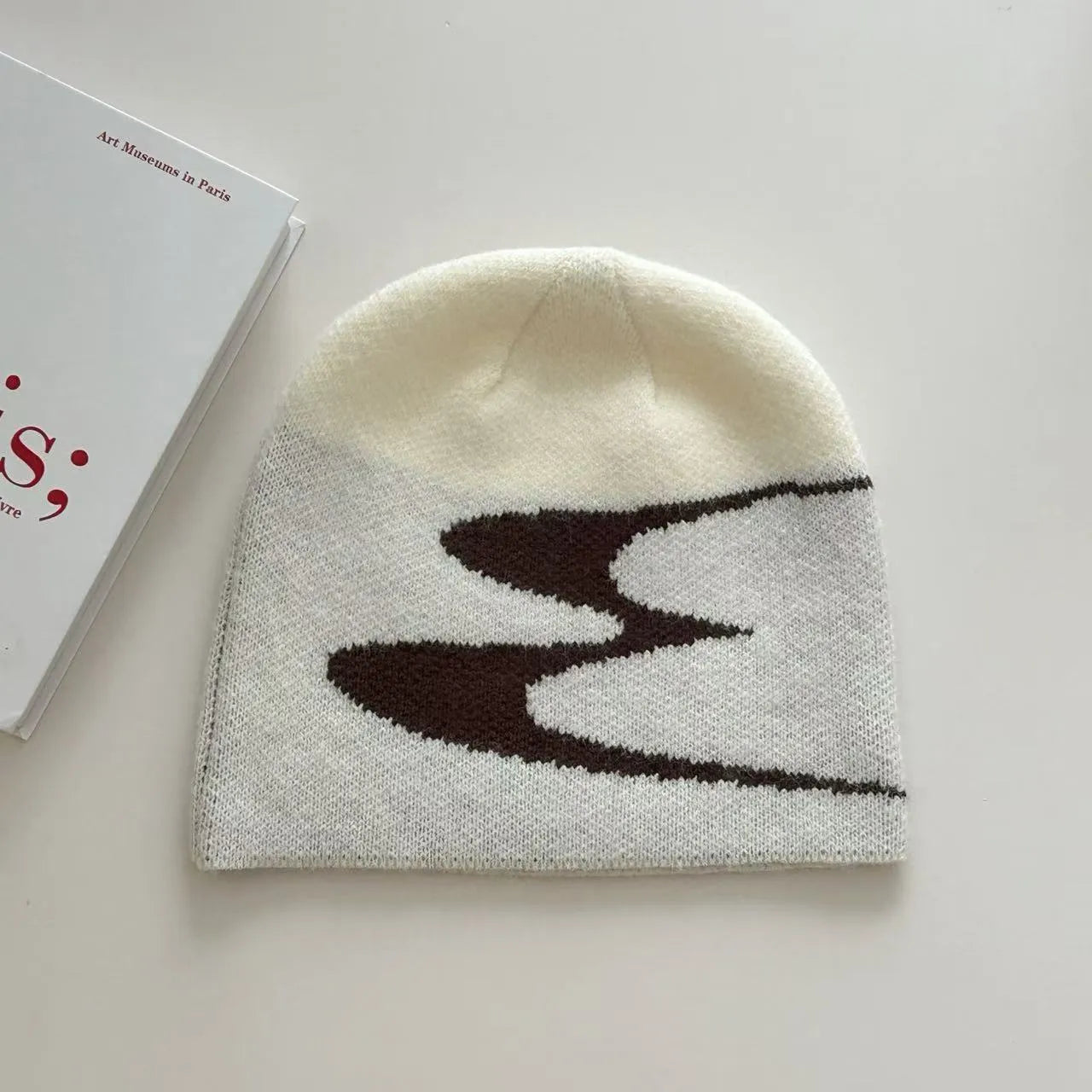 Acrylic thermal knit beanie hat in black, shown on a model, illustrating its textured anti-fall design.