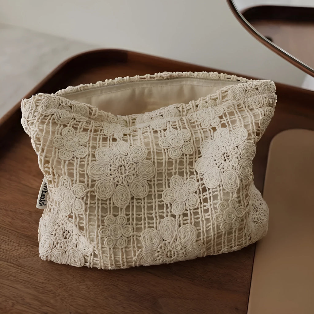 Handmade crocheted cosmetic bag with floral embroidery on corduroy fabric and rope drawstring