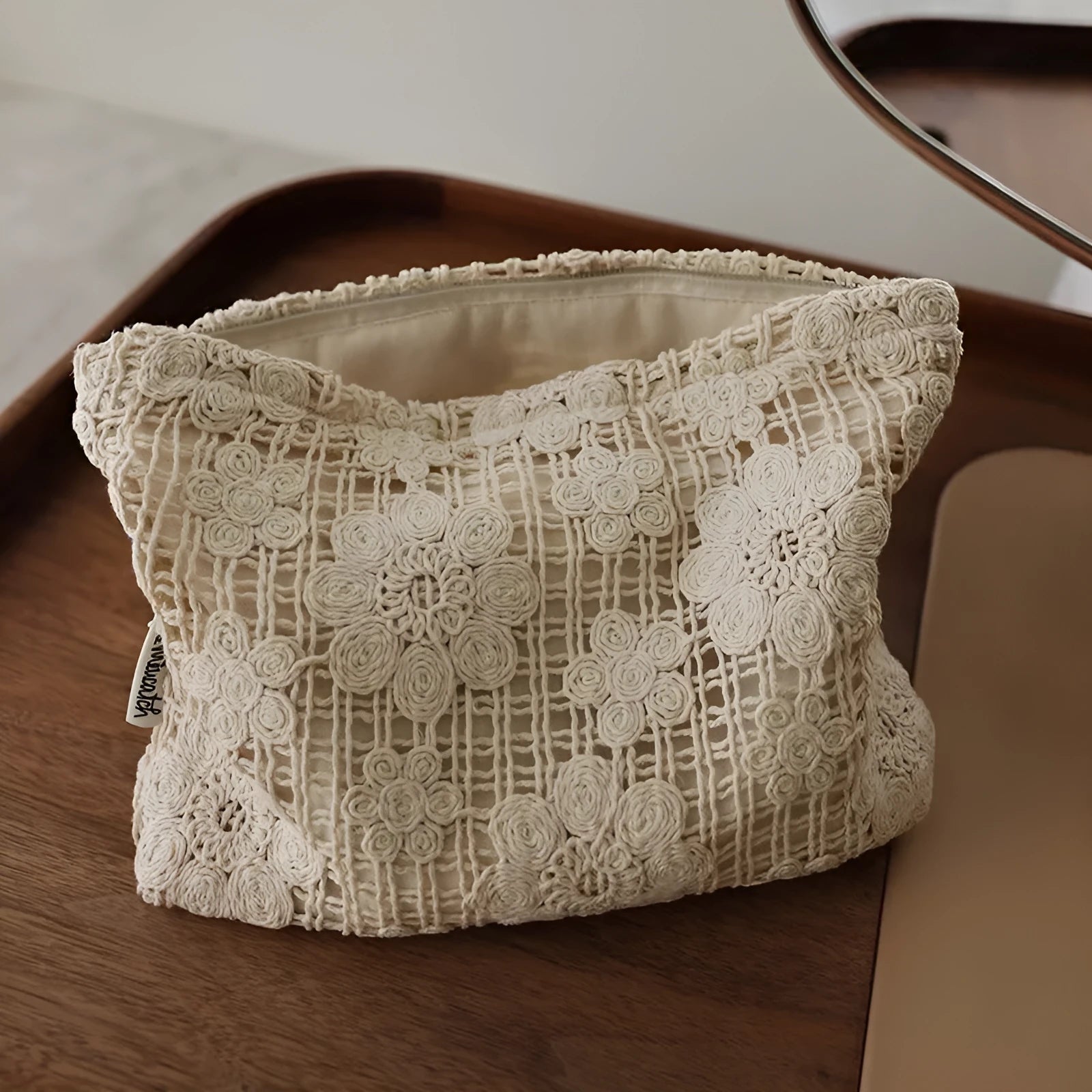 Handmade crocheted cosmetic bag with floral embroidery on corduroy fabric and rope drawstring