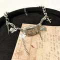Dark multi-layer cross pendant necklace with a textured hemp flowers chain, adjustable from 41cm to 50cm.