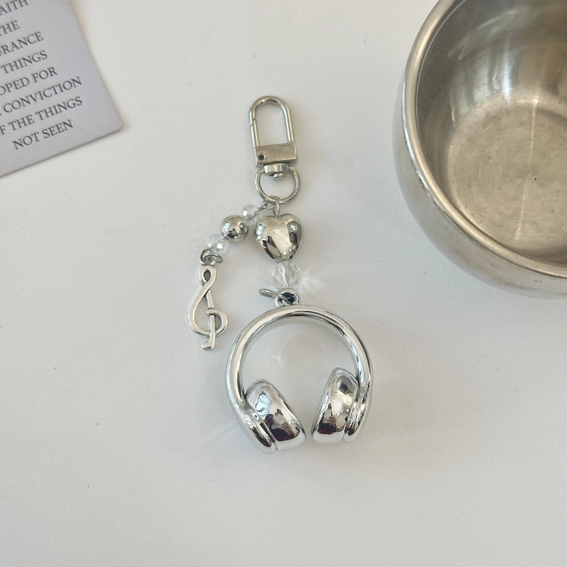 Creative music headset keychain with gradient blue resin earphone pendant and alloy keyring on a plain background