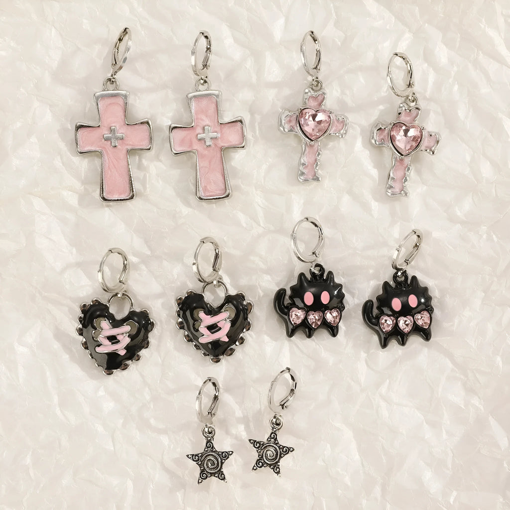 Women's alloy crystal earrings showing five colour options: white cross, white peach heart, white cross, black cat, and antique silver star design.