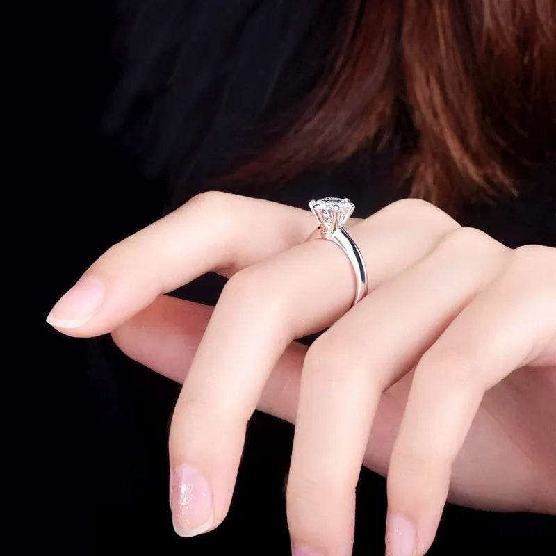 White gold plated women's ring with six-claw cubic zirconia setting on geometry shaped band