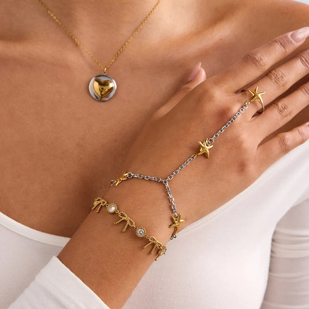 Women's stainless steel starfish mitten-type bracelet in gold and silver geometric chain style