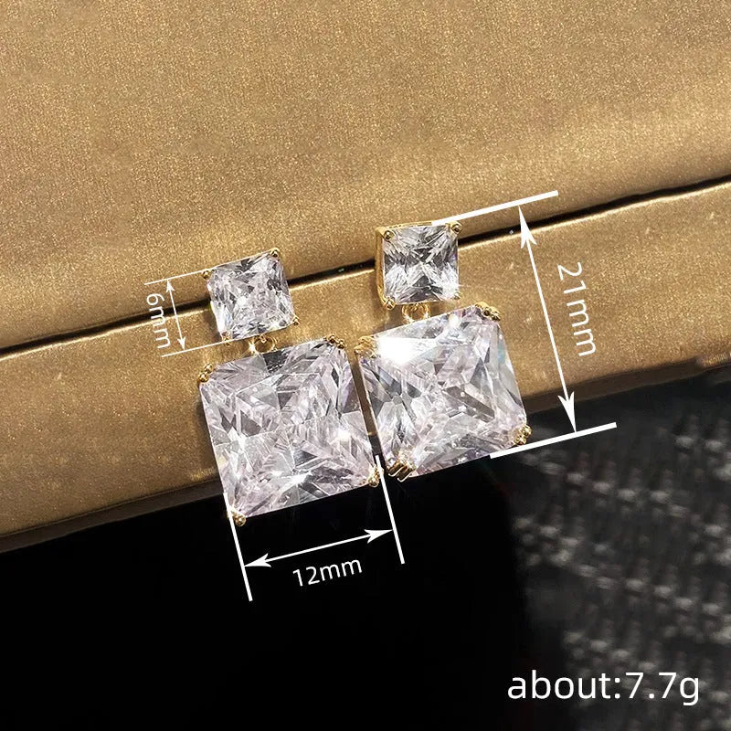 A pair of geometric square-shaped copper earrings for women, shown in white gold and gold colour options.