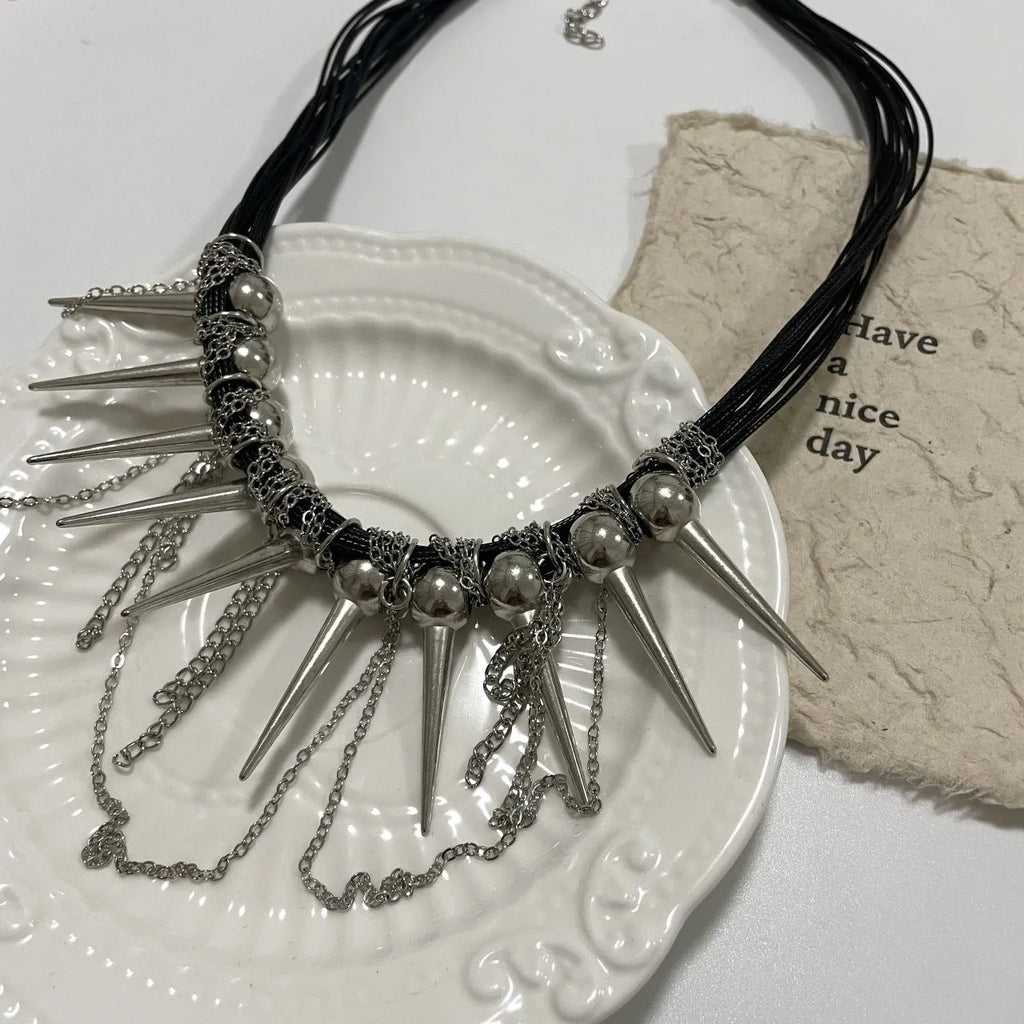 Women's rivet round beads winding tassel necklace with leather cord and electroplated brass accents.