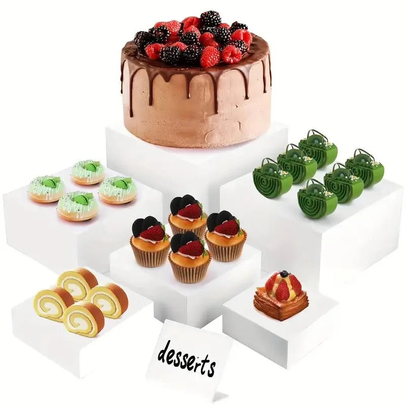 White plastic stackable dessert display stand with six pieces arranged in tiered formation