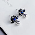 Blue lotus flower stud earrings with a detailed seedpod tassel drop, retro design.