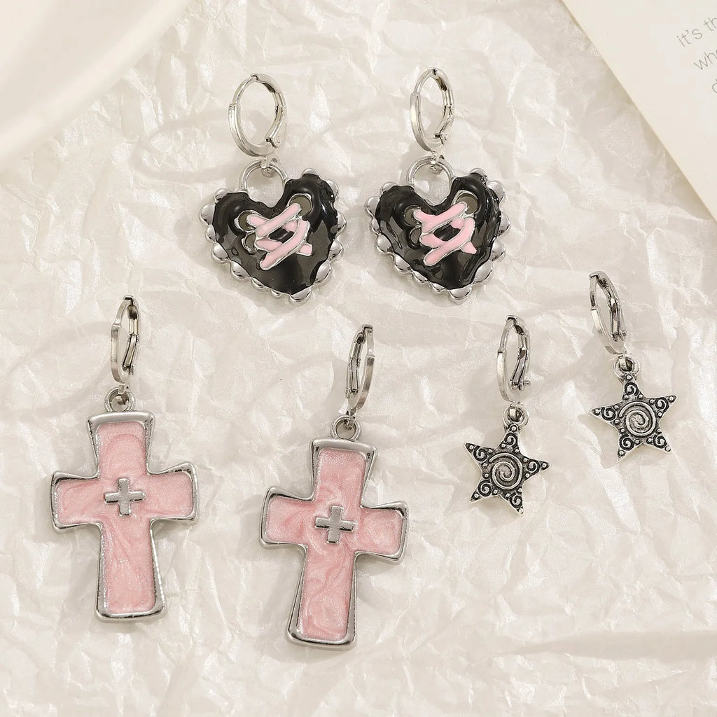 Women's alloy crystal earrings showing five colour options: white cross, white peach heart, white cross, black cat, and antique silver star design.