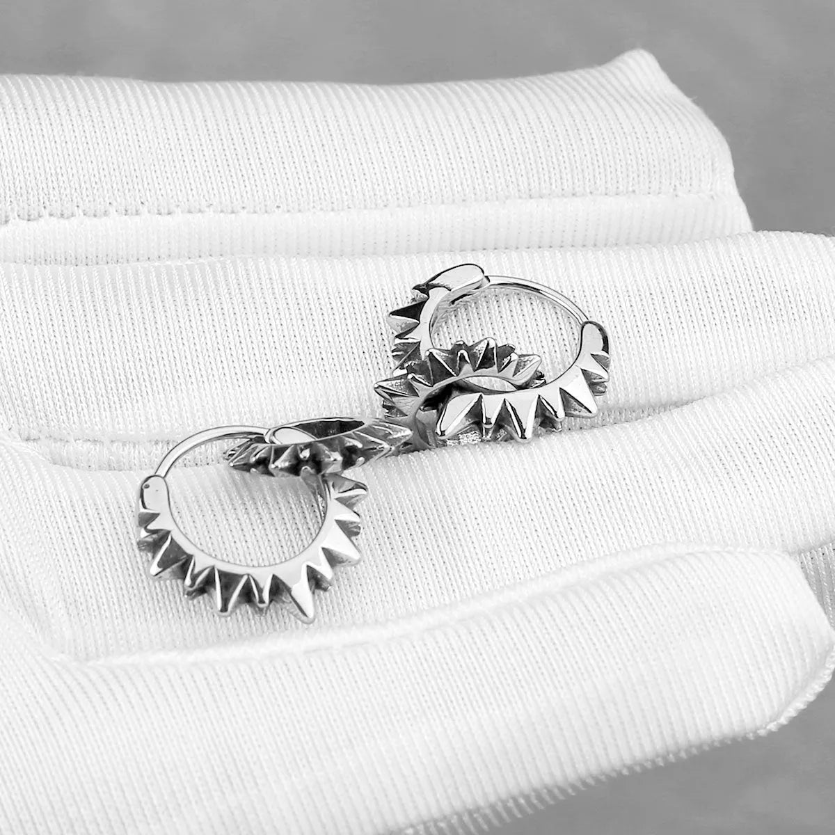 Stainless steel round ring earrings with polished finish showing circular design