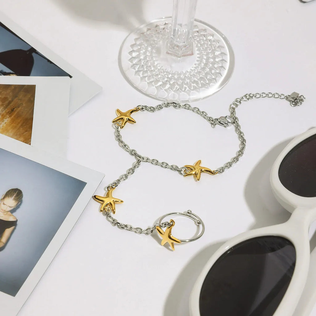 Women's stainless steel starfish mitten-type bracelet in gold and silver geometric chain style